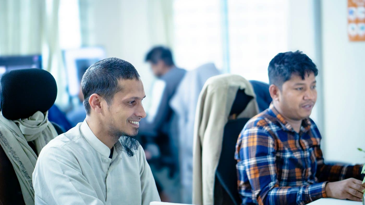 Two team members reviewing results together at their desks